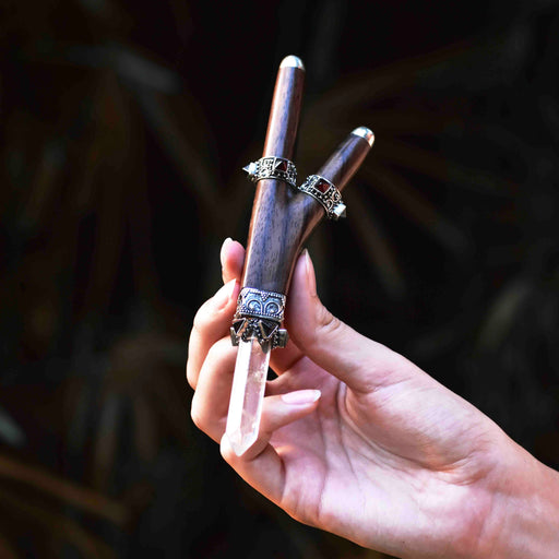 Handcrafted rosewood and sterling silver kuripe pipe, adorned with quartz and garnet, presented as a unique, high-quality tool for hape snuff rituals.