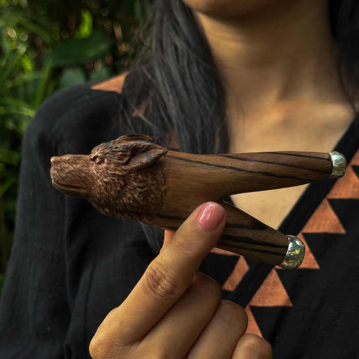Wooden Star Trek ship model held by a person with a blurred background