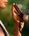 Close-up of a man using a Handmade Double Hape Kuripe, a shamanic ceremony tool for Rapé snuff application, showcasing the pipe&#39;s intricate sacred geometry and totem design for spiritual healing, meditation, and protection