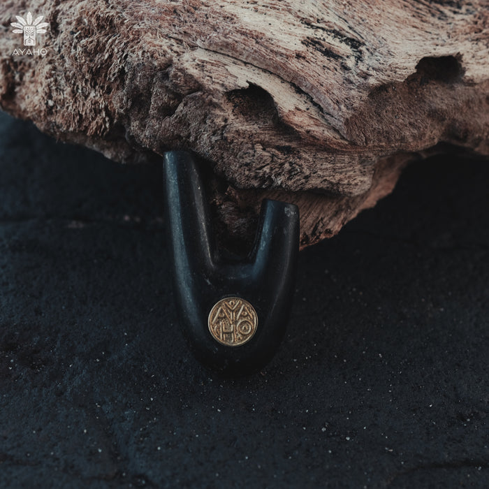 Bronze logo on Kuripe made from volcanic stone, adding sophistication.