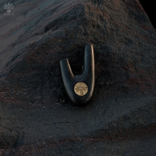 Kuripe made from volcanic stone with a bronze logo, elegant and stylish.