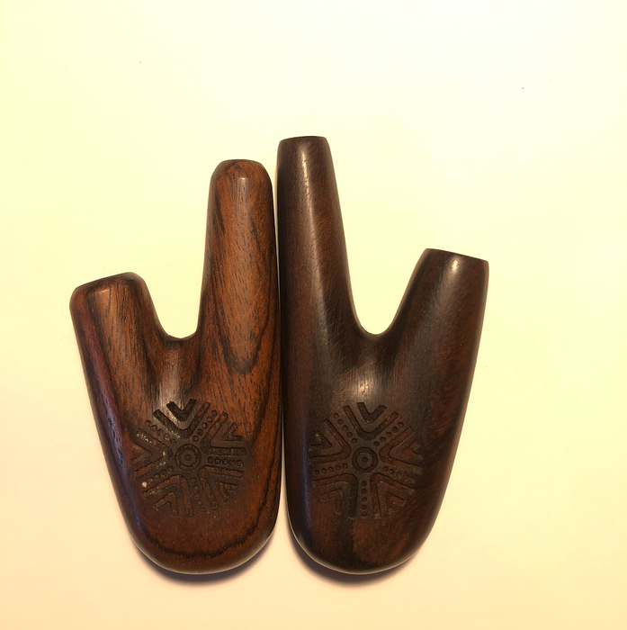 Pair of wooden bootjack tools on a beige background