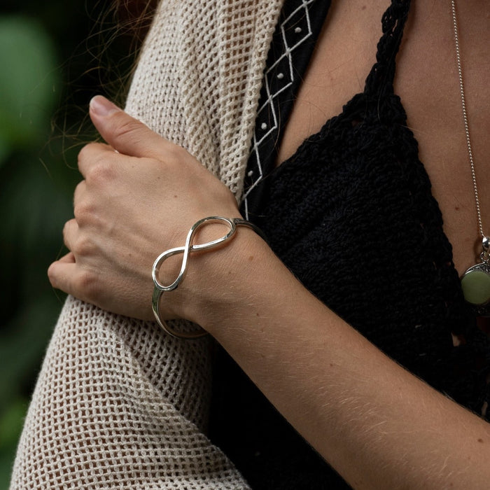 Sleek sterling silver bracelet featuring an infinity symbol, meticulously handcrafted to promote energy flow and serve as a protective talisman