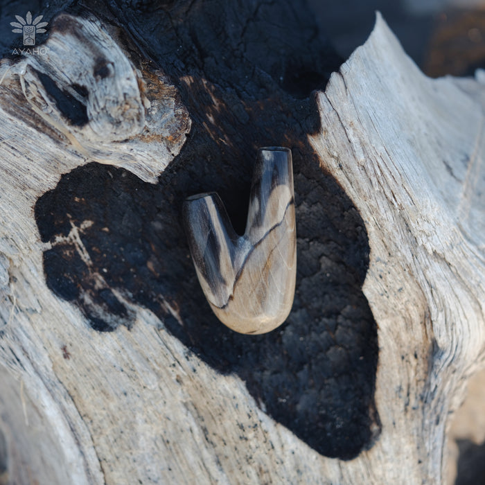 Distinctive character of the Kuripe pipe crafted from petrified wood, unique to each piece.