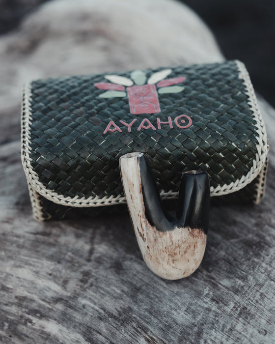 Earthy textures of the Kuripe pipe made from petrified wood, enhancing its tactile quality.