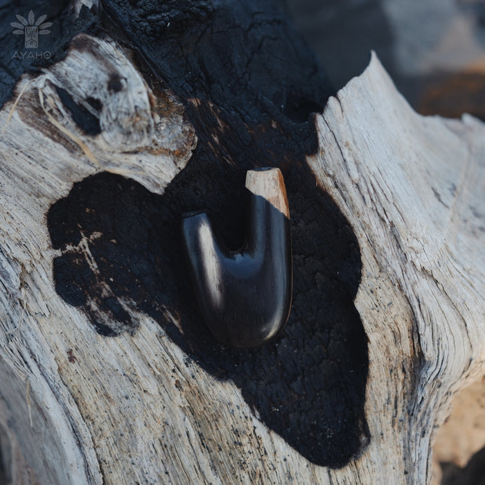 Elegant silhouette of the Kuripe pipe made from petrified wood, a stylish accessory.