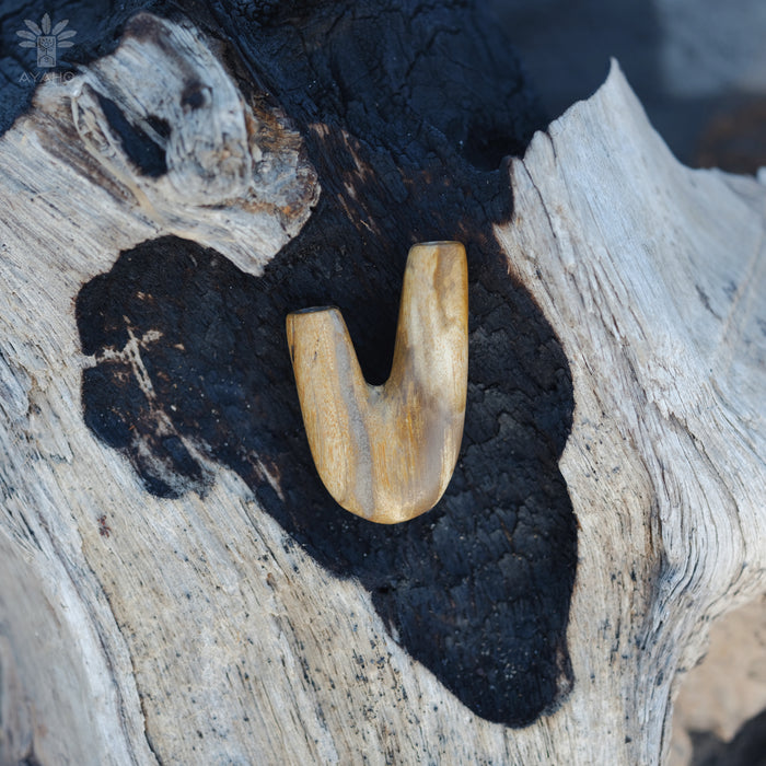 Natural beauty of the Kuripe pipe crafted from petrified wood, perfect for collectors.