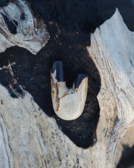  Nature's art in the Kuripe pipe crafted from petrified wood, showcasing its history.