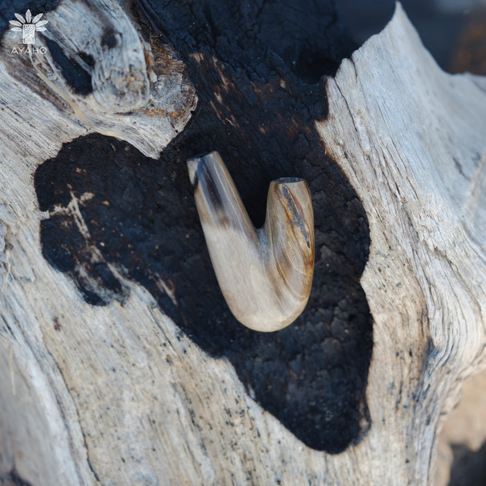 Organic shapes of the Kuripe pipe made from petrified wood, reflecting nature's design.

