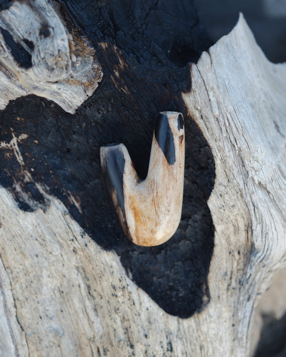Smooth finish of the Kuripe pipe made from petrified wood, enhancing its tactile appeal.
