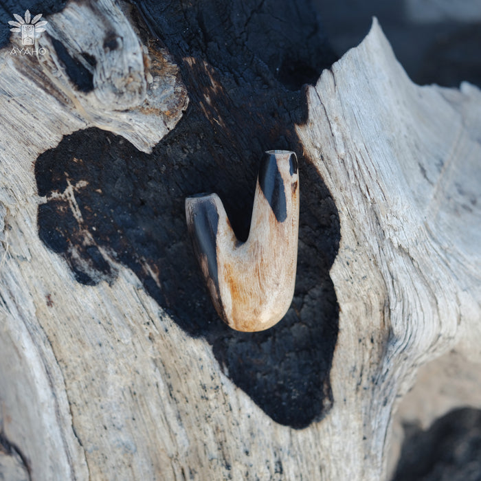 Smooth finish of the Kuripe pipe made from petrified wood, enhancing its tactile appeal.