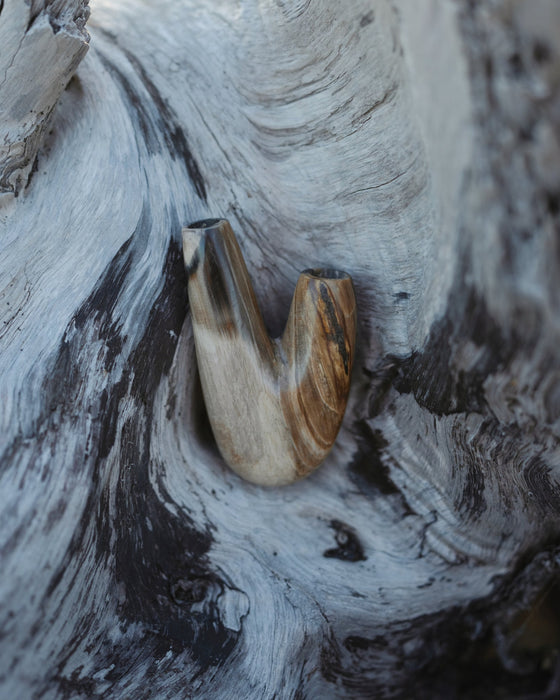 Timeless appeal of the Kuripe pipe made from petrified wood, a classic choice.