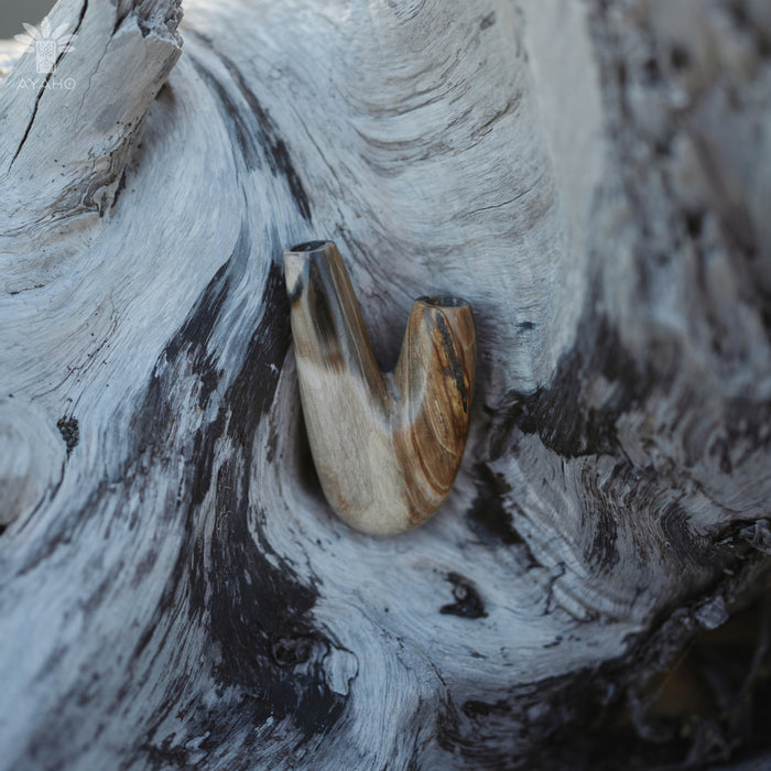 Timeless appeal of the Kuripe pipe made from petrified wood, a classic choice.