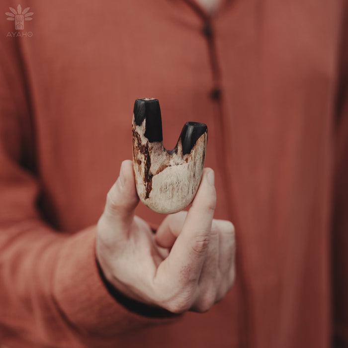 Unique grain patterns in the Kuripe pipe crafted from petrified wood, showcasing individuality.