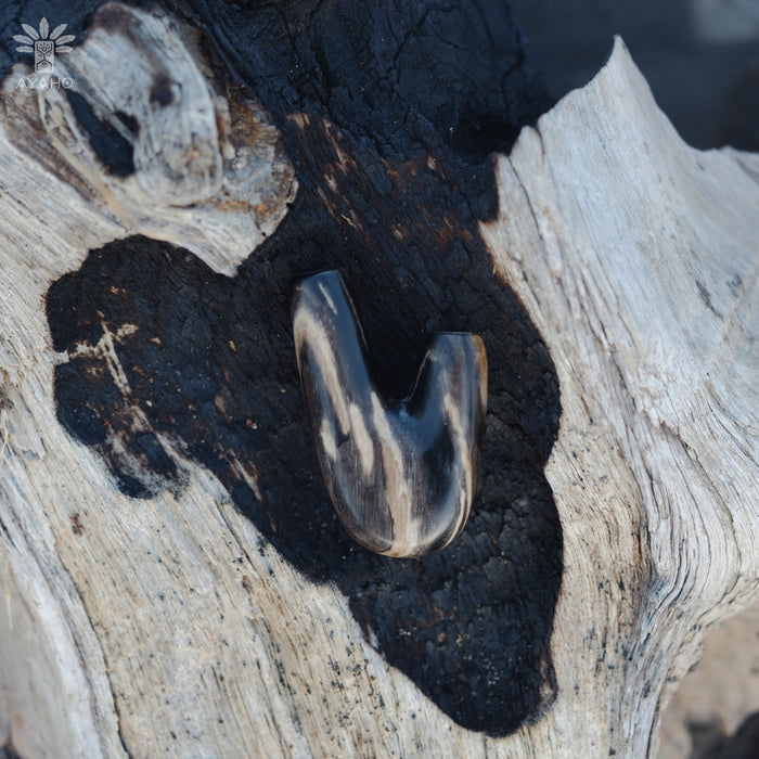 Unique patterns of petrified wood in the Kuripe pipe, highlighting its organic origins.