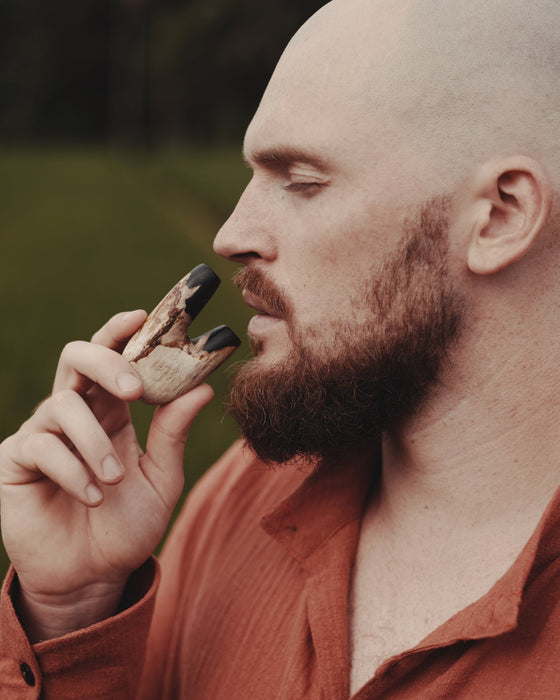 Warm natural tones of the Kuripe pipe made from petrified wood, inviting and soothing.