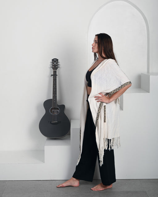 Lightweight yet warm shaman-style poncho featuring hand-woven details and earthy boho aesthetics, ideal for layering in any bohemian wardrobe."Lightweight yet warm shaman-style poncho featuring hand-woven details and earthy boho aesthetics, ideal for layering in any bohemian wardrobe."