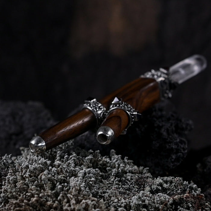 Handcrafted rosewood and sterling silver kuripe pipe, adorned with quartz and garnet, presented as a unique, high-quality tool for hape snuff rituals.