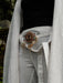 Handcrafted eagle feather brooch with painted details, symbolizing earth energy and spiritual transition, pinned to a tribal-printed shawl