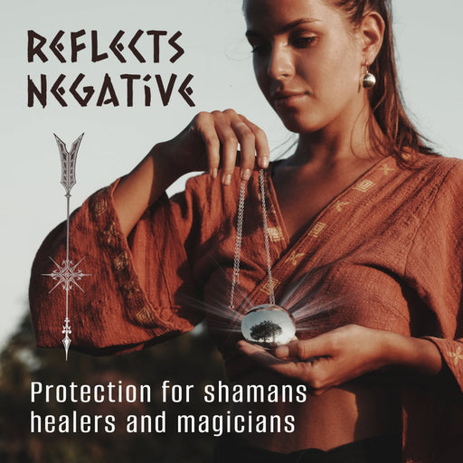 A woman presents a shamanic set featuring a copper mirror amulet necklace and minimalist silver earrings, embodying boho chic. These unique, handmade pieces serve as talismans for meditation, and protection, symbolizing spiritual gifts