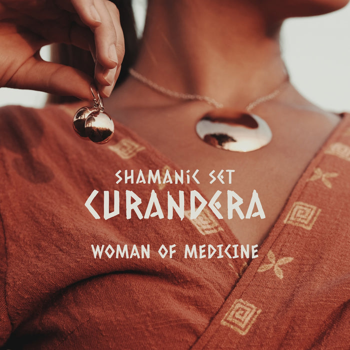Pair of silver mirror earrings resting on dark volcanic sand,reflecting a minimalist and boho aesthetic.These dangle earrings,handcrafted as spiritual amulets,a unique charm for protection and meditation,embodying the essence of shamanic jewelry