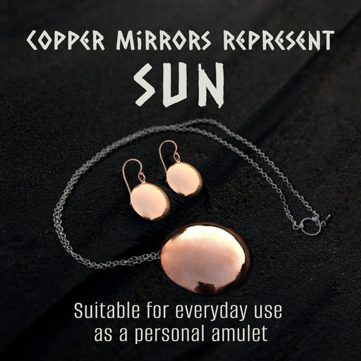 Pair of silver mirror earrings resting on dark volcanic sand,reflecting a minimalist and boho aesthetic.These dangle earrings,handcrafted as spiritual amulets,a unique charm for protection and meditation,embodying the essence of shamanic jewelry