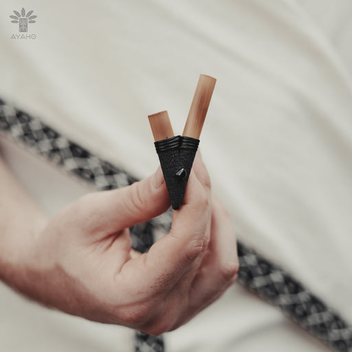 Artisan-crafted nasal pipe made from fire-treated bamboo, adorned with natural stones for spiritual medicine administration