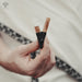 Artisan-crafted nasal pipe made from fire-treated bamboo, adorned with natural stones for spiritual medicine administration
