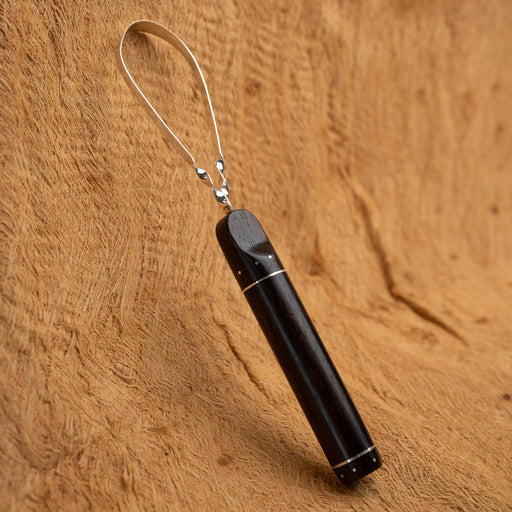 High-quality metal tongue scraper removing bacteria and plaque with gentle curved edge, shown against a clean white bathroom background.