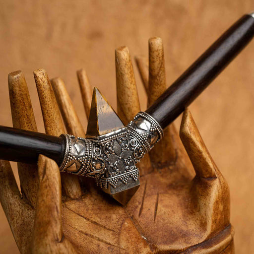 Close-up of a high-quality, handcrafted tepi pipe adorned with tigers eye stone and sterling silver, designed for hape snuff application, highlighting shamanic tool tradition.