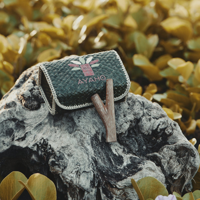 Teakwood kuripe alongside hape snuff, illustrating its use in traditional healing practices