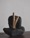 Teakwood kuripe displayed with sacred objects, symbolizing its role in spiritual ceremonies