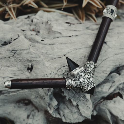 Close-up of a high-quality, handcrafted tepi pipe adorned with black onyx and sterling silver, designed for hape snuff application, highlighting shamanic tool tradition.