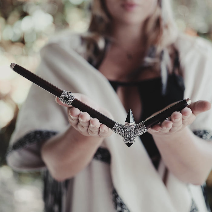 Close-up of a high-quality, handcrafted tepi pipe adorned with black onyx and sterling silver, designed for hape snuff application, highlighting shamanic tool tradition.