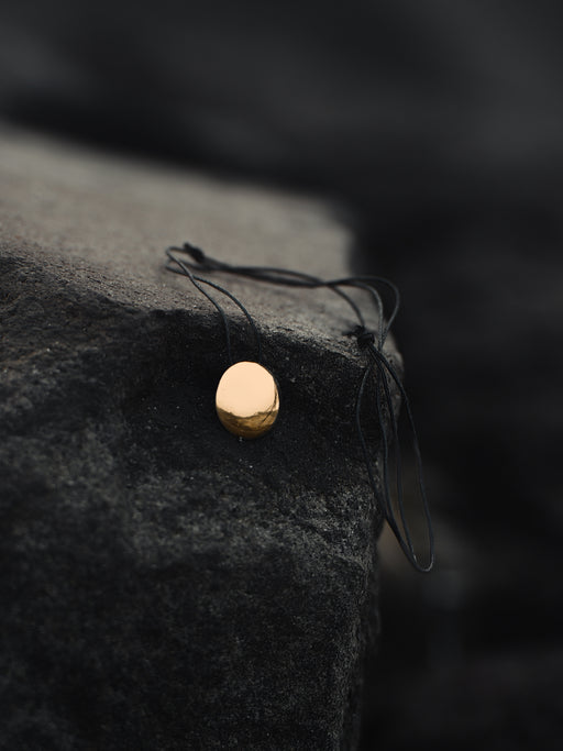 Small copper mirror pendant on an adjustable cord, tucked into a suede pouch for on-the-go spiritual practice.