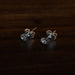 Close-up of hand-engraved floral stud earrings with cubic zirconia centers, displayed on a rustic wooden tray with dried lavender for boho charm.