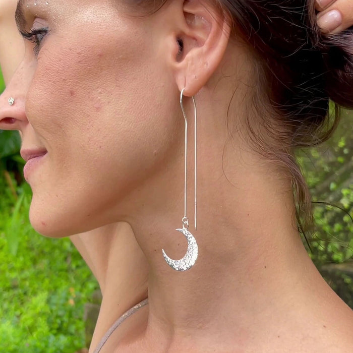 Charming mismatched silver earrings depicting the sun and moon, crafted as aesthetic shamanic tools and serving as a unique talisman for celestial harmony.