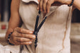 Person holding a black bow with a blurred background