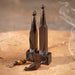 Wooden incense holders with smoke on a sandy background
