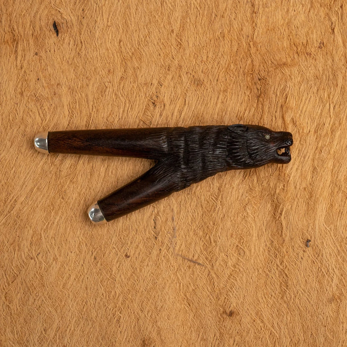 Wooden animal-shaped tool on a wooden surface
