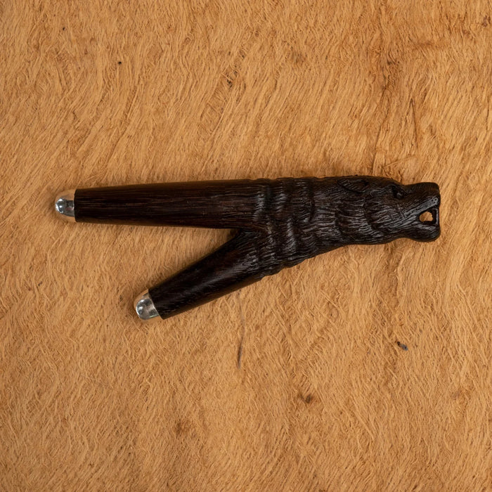 Wooden object with bear design on a wooden surface