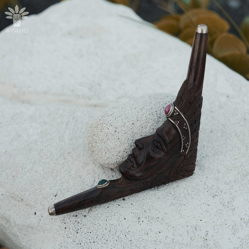 Decorative wall hook with face design on a textured surface