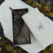 Wooden smoking accessory in a box with Ayaho branding on a textured surface.
