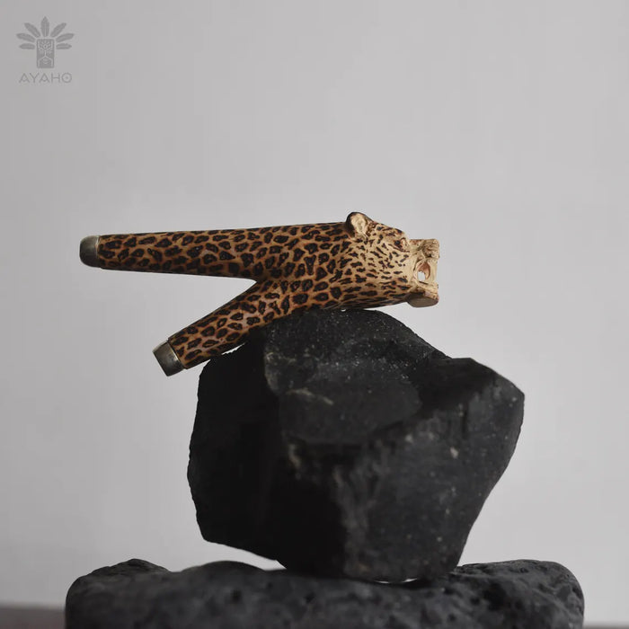 Leopard print ring on a black stone with 'AYAHQ' branding.