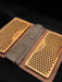 Two wooden massage boards with a brown leather case on a black background