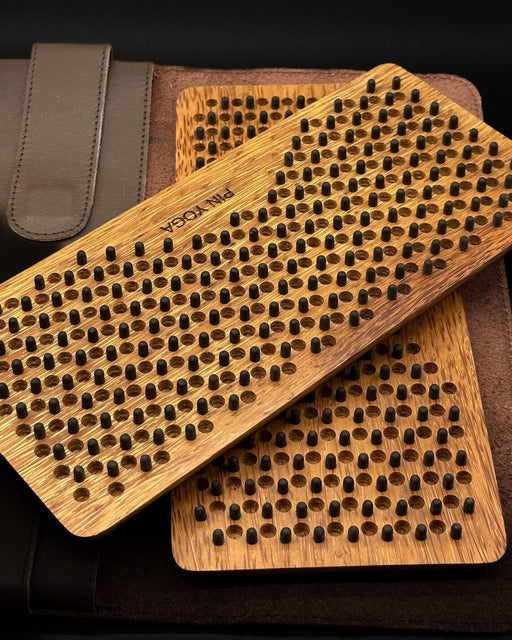 Two wooden brush scrubbers with textured surface on a dark background