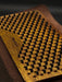 Wooden brush with black bristles on a dark background