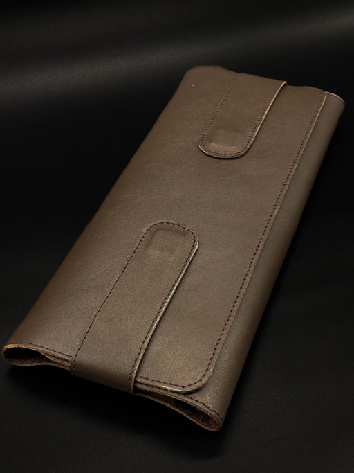 Brown leather wallet on a black background