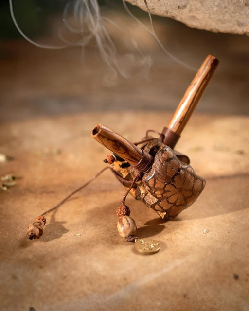 Incense burner with cinnamon sticks on a textured surface