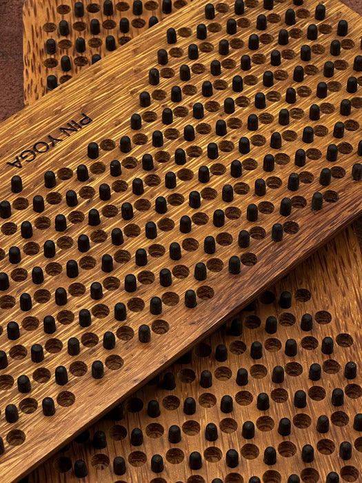 Wooden yoga mat with textured surface and brand name 'Pam Yoga' visible.